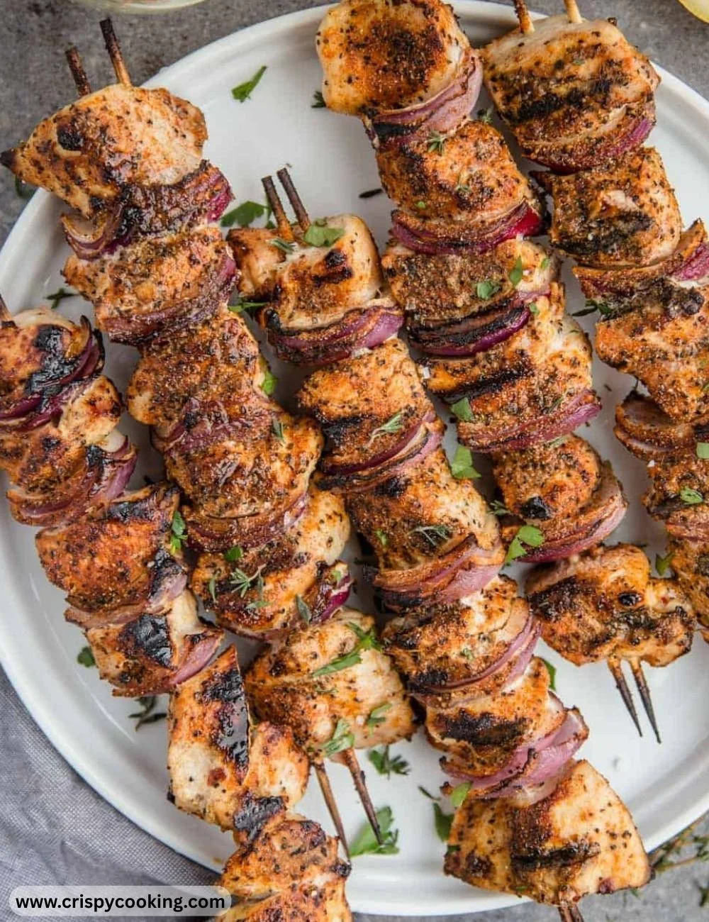 Delicious grilled chicken kabobs served on skewers with colorful vegetables.