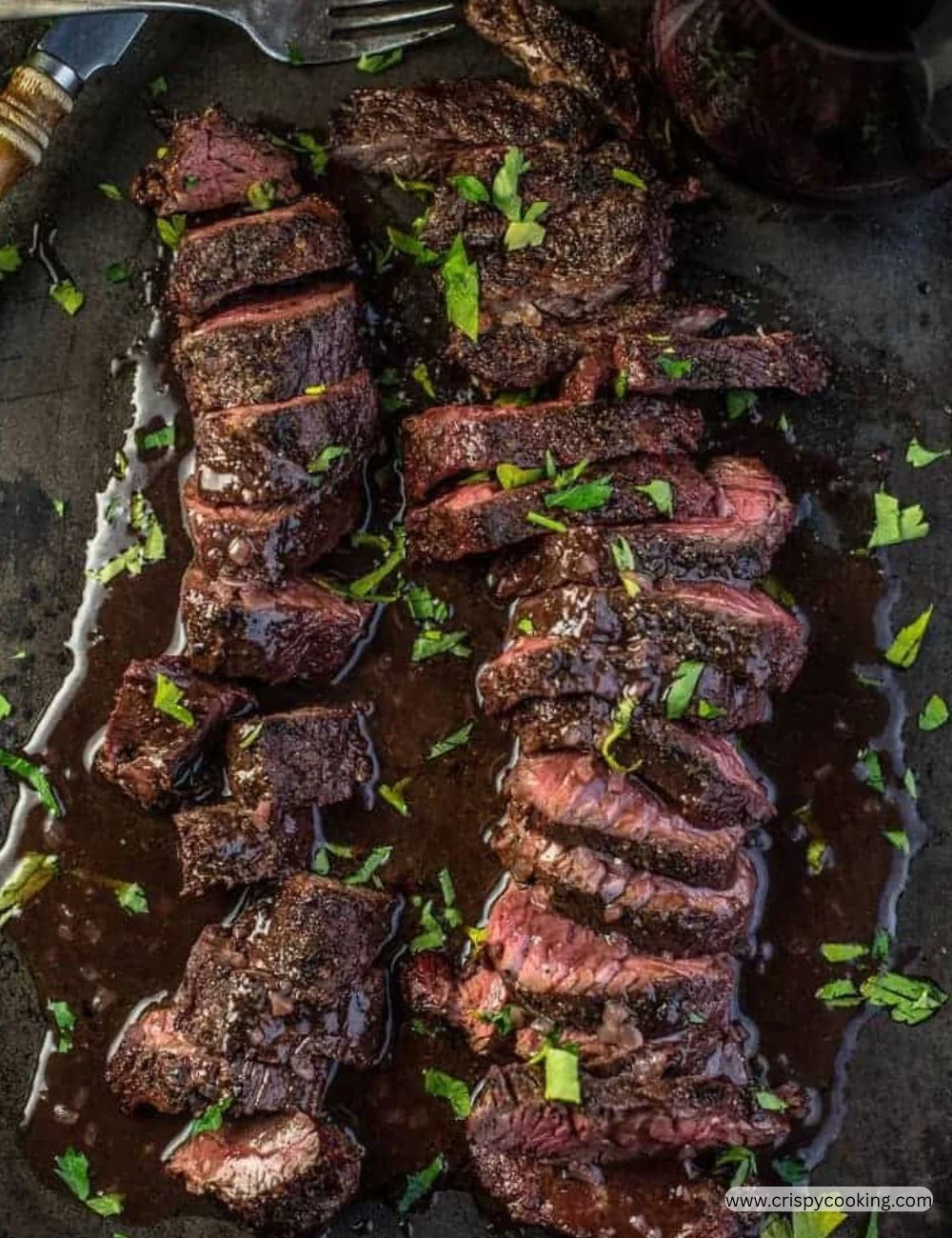 Grilled hanger steak served with vegetables and herbs