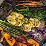 Colorful plate of grilled vegetables including zucchini, peppers, and eggplant