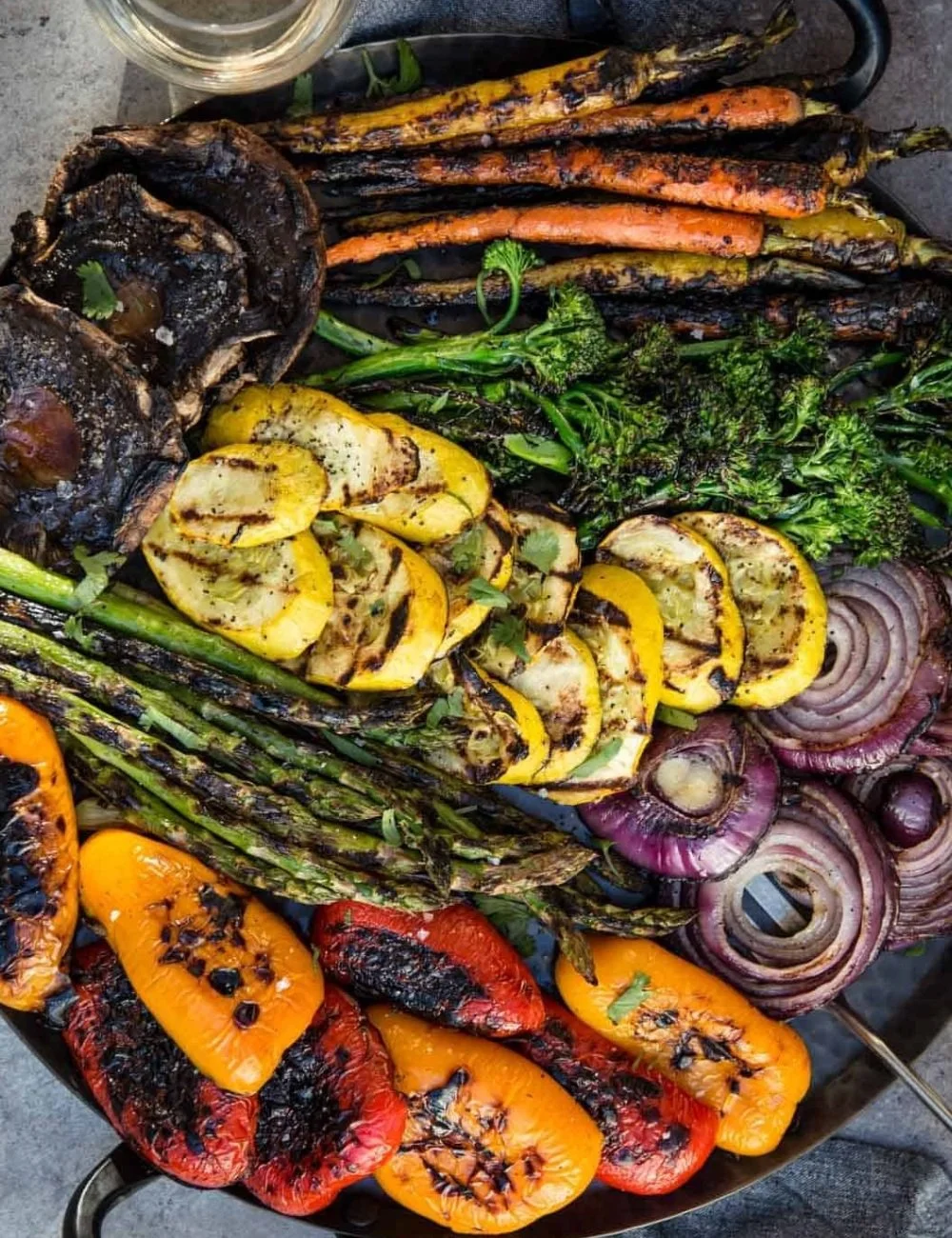 Colorful plate of grilled vegetables including zucchini, peppers, and eggplant