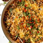 Ground beef and rice casserole served in a baking dish with melted cheese on top