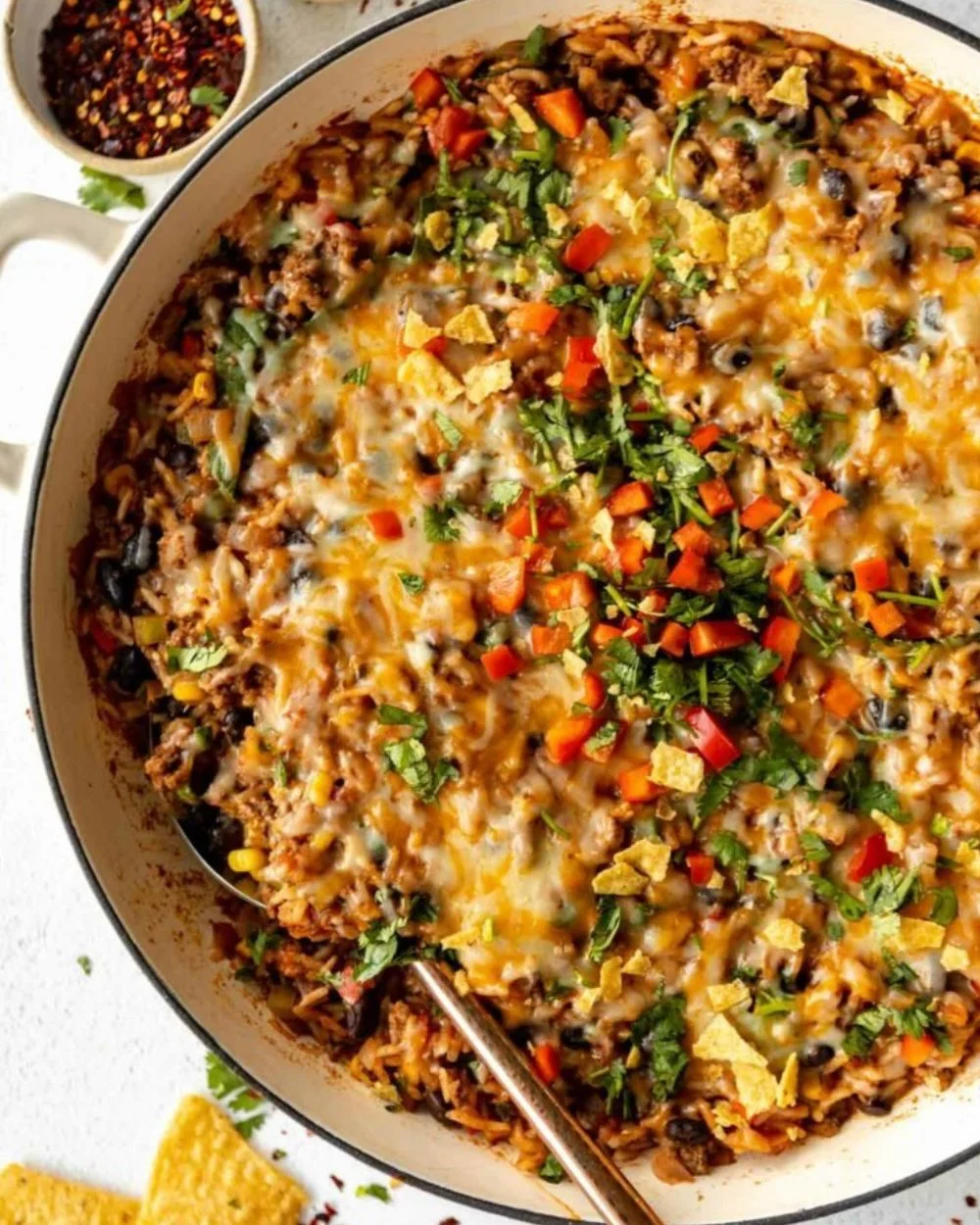 Ground beef and rice casserole served in a baking dish with melted cheese on top
