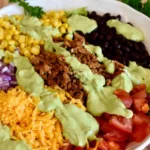 Healthy ground turkey taco salad topped with avocado in a bowl