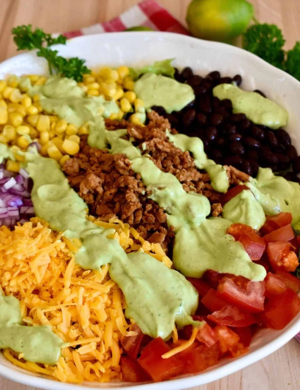 Healthy ground turkey taco salad topped with avocado in a bowl