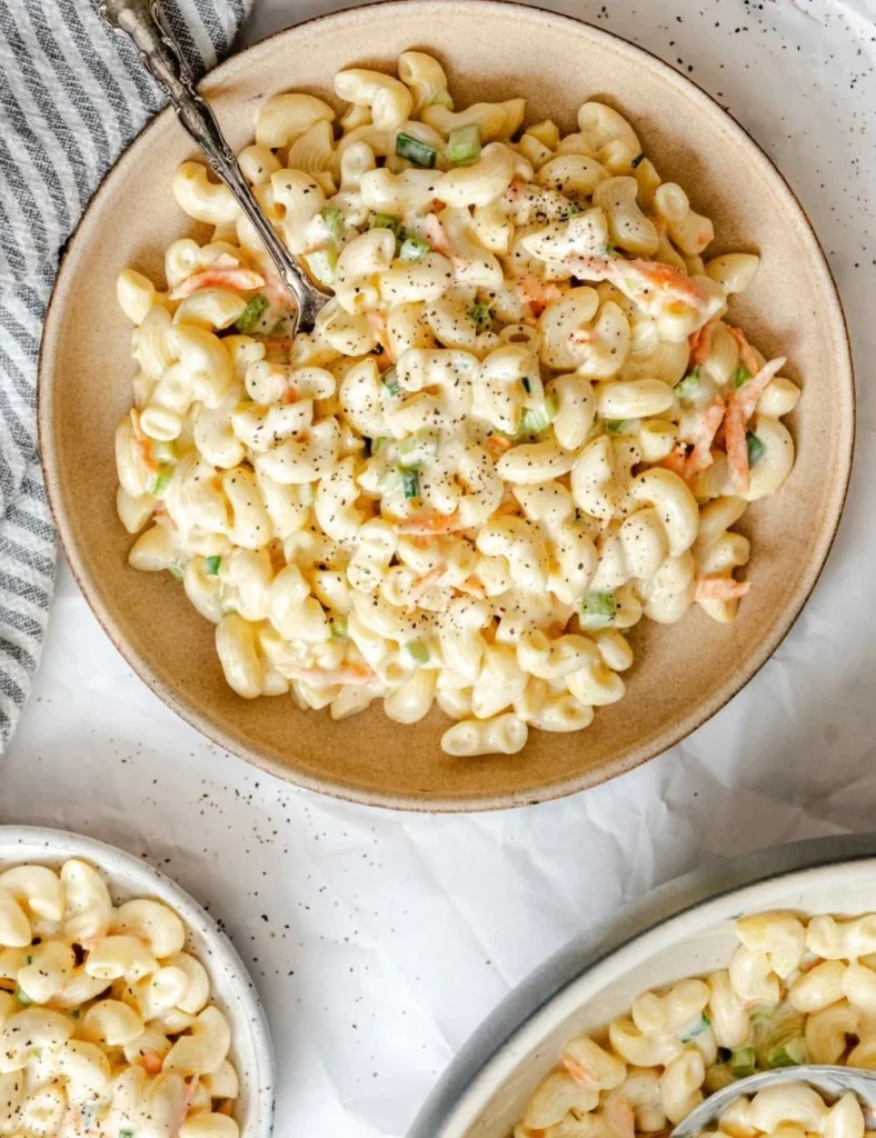 Bowl of creamy Hawaiian macaroni salad with vegetables and seasonings