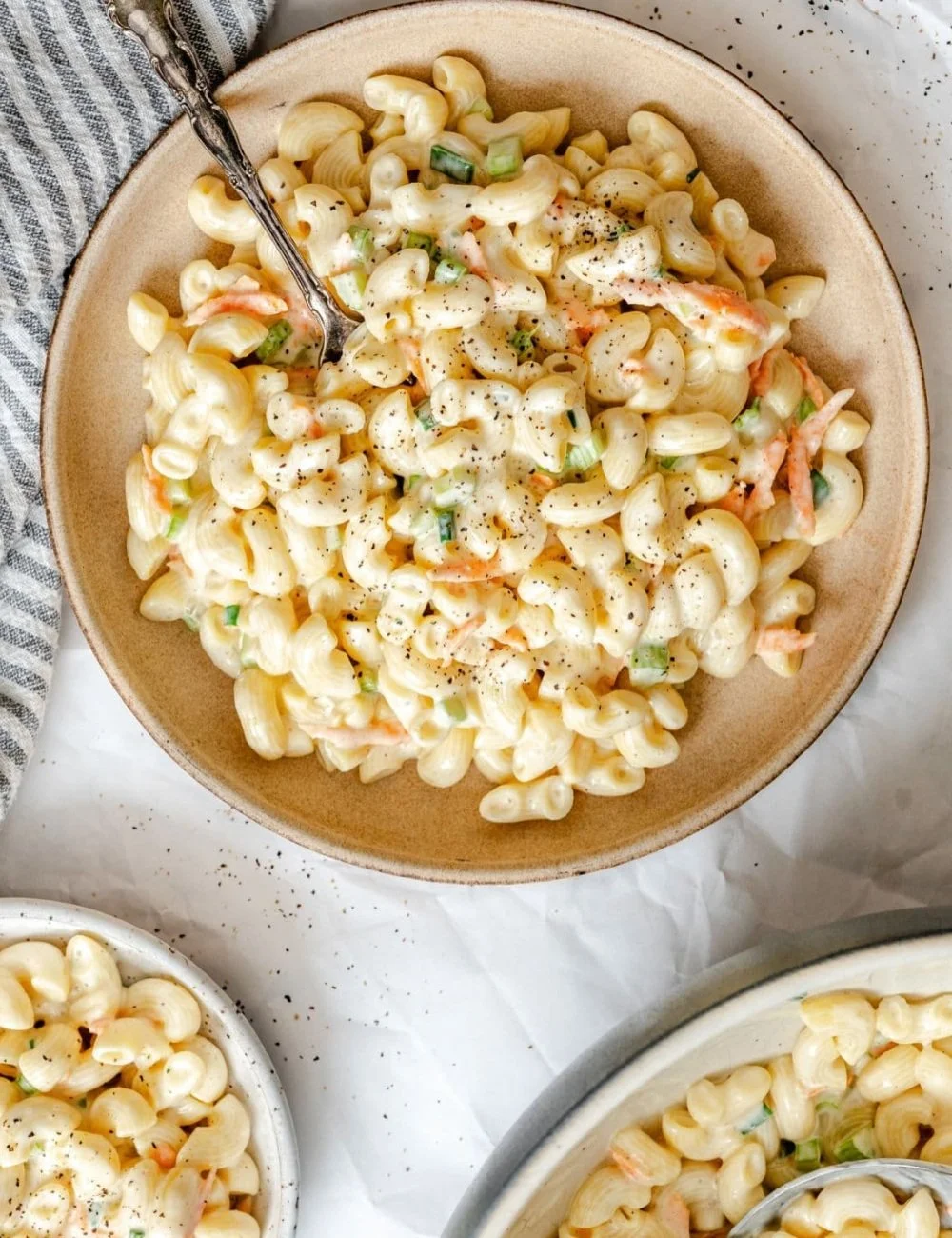 Bowl of creamy Hawaiian macaroni salad with vegetables and seasonings
