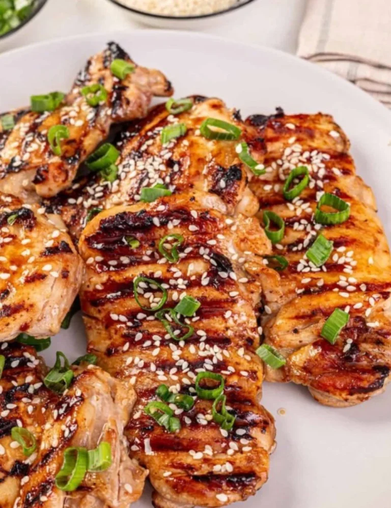 Delicious Korean BBQ Chicken served on a grill with vibrant vegetables.