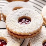 Delicious Linzer Cookies with jam filling and powdered sugar topping