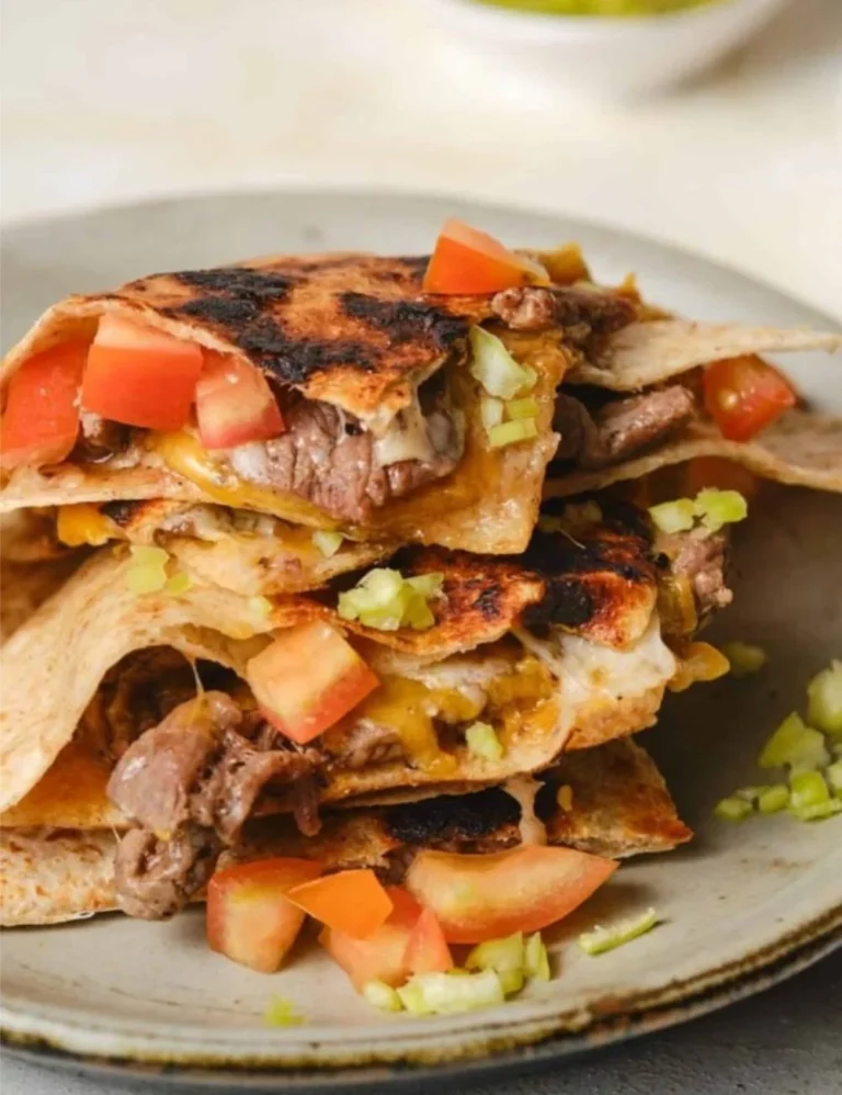 Deliciously stacked mulitas with savory meat, cheese, and salsa on a warm tortilla.
