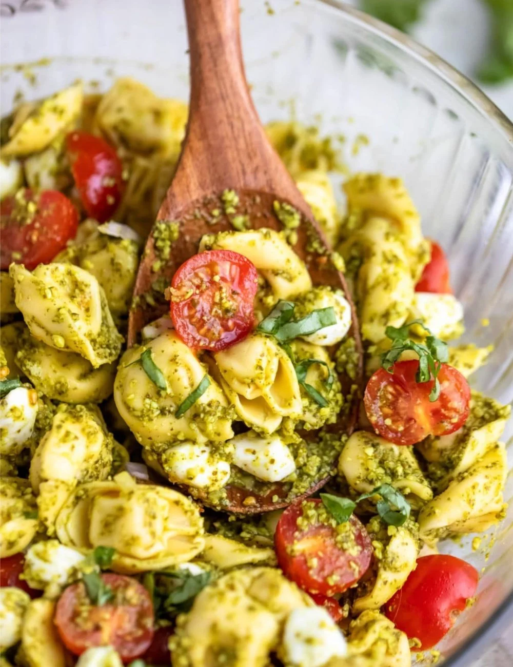 Pesto tortellini pasta salad with fresh vegetables and herbs