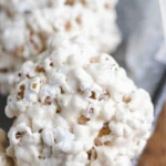 Homemade popcorn balls decorated with colorful sprinkles and candies