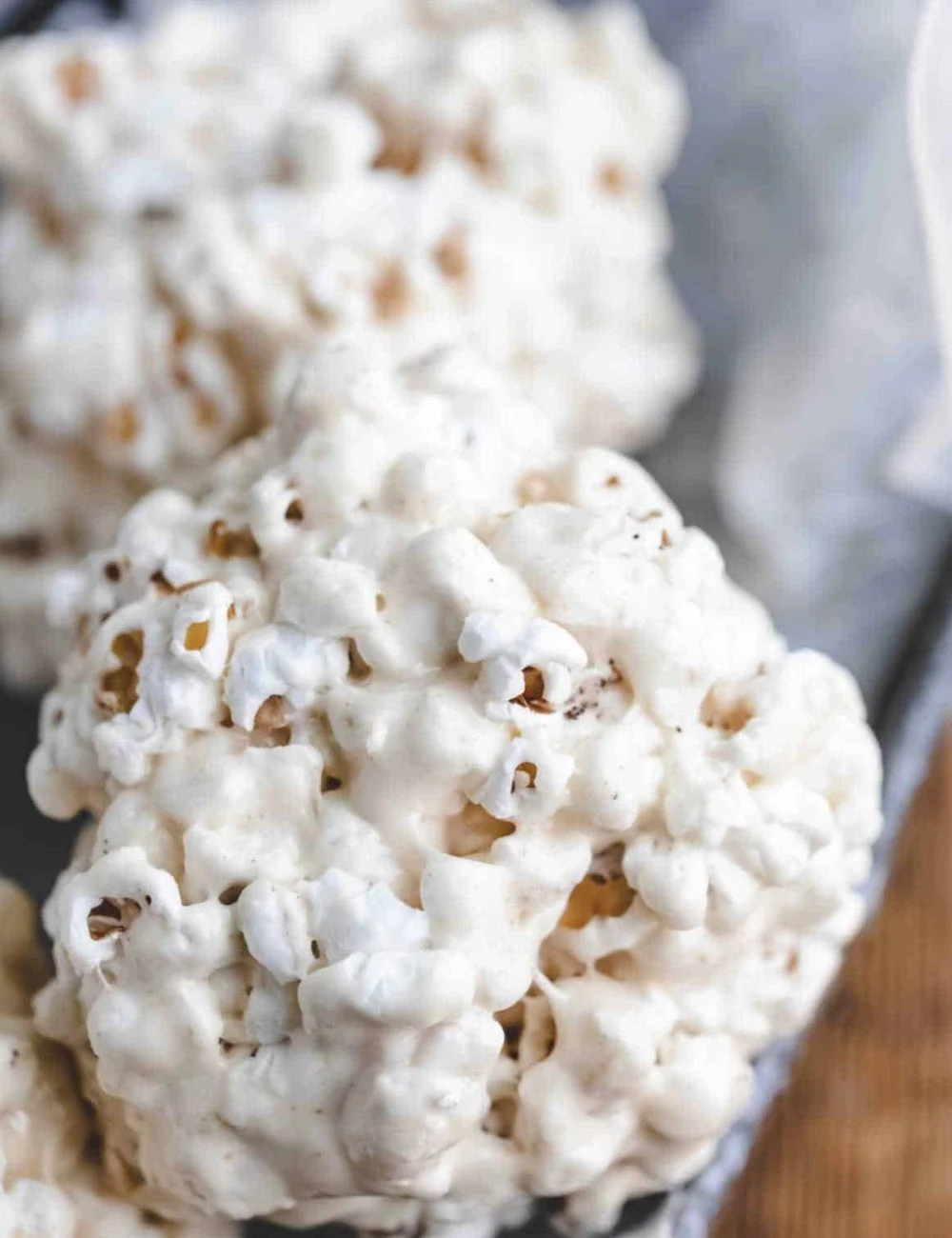 Homemade popcorn balls decorated with colorful sprinkles and candies