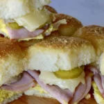 Delicious Pull Apart Cuban Sliders with pork, cheese, and mustard on a platter