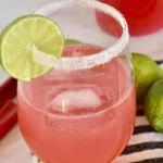 Refreshing Rhubarb Cocktail garnished with fresh herbs and served in a glass