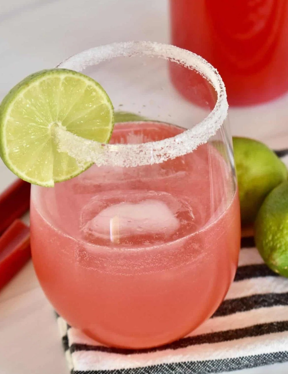 Refreshing Rhubarb Cocktail garnished with fresh herbs and served in a glass