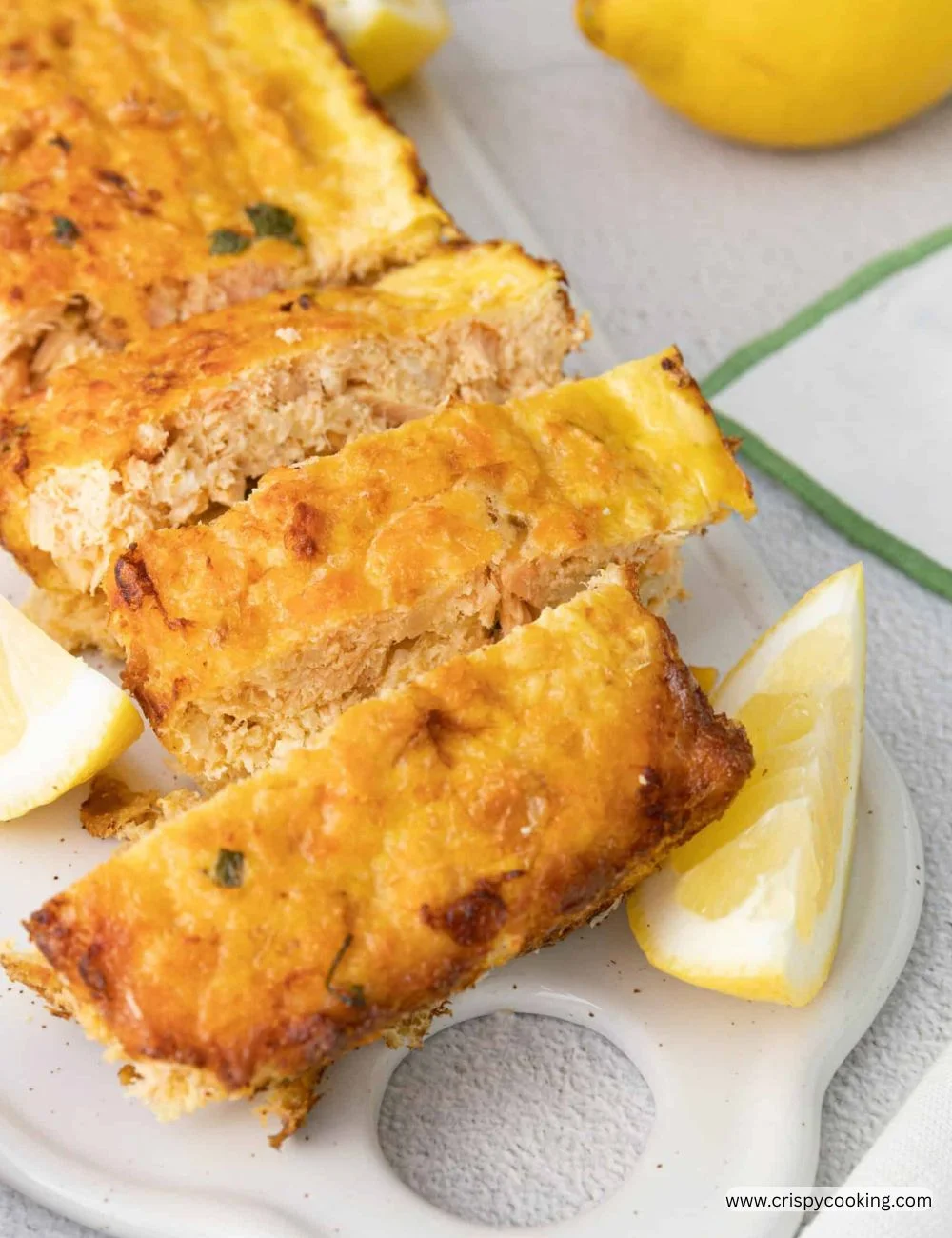 Baked salmon loaf garnished with herbs and lemon slices for a delicious presentation