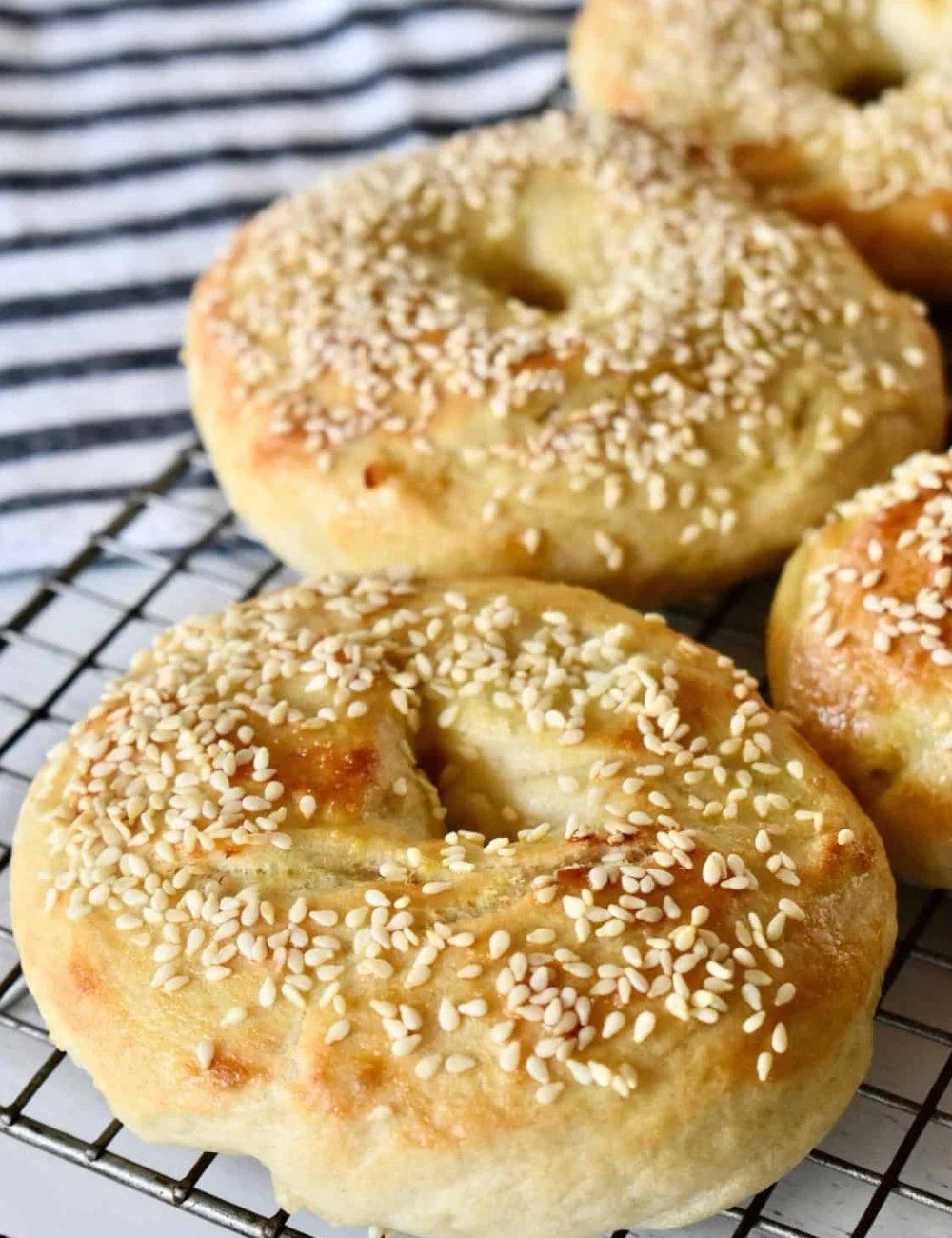 Freshly baked sesame bagels with a golden crust and sesame seeds on top.