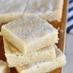 Delicious shortbread cookie bars topped with a drizzle of chocolate