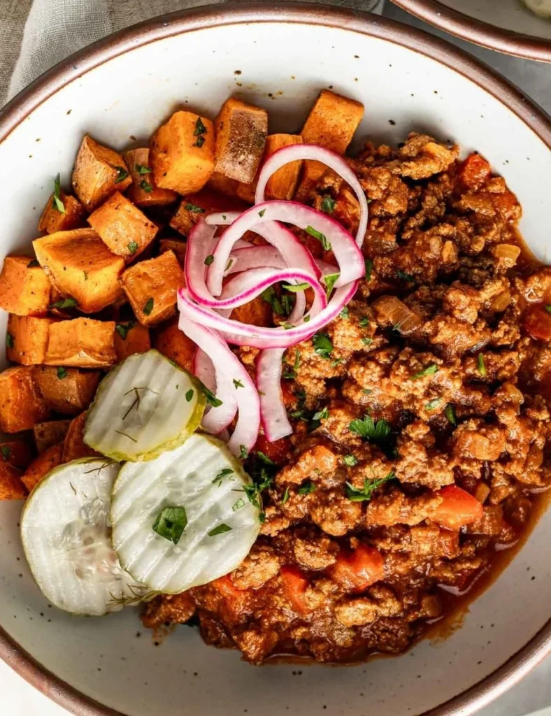 Delicious Sloppy Joe Bowls served with fresh toppings in a rustic bowl.