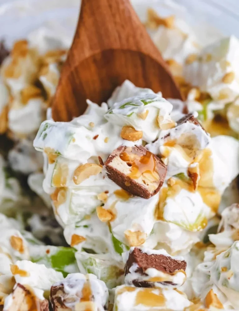 Delicious Snickers Salad with apples, caramel, and whipped cream