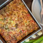 Delicious Tater Tot Breakfast Casserole topped with cheese and eggs.