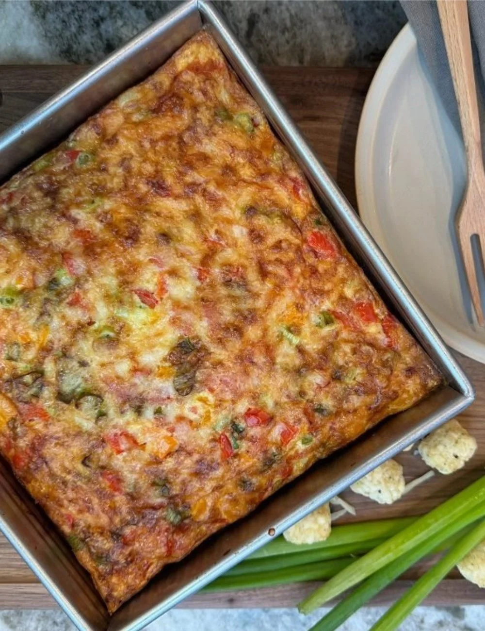 Delicious Tater Tot Breakfast Casserole topped with cheese and eggs.