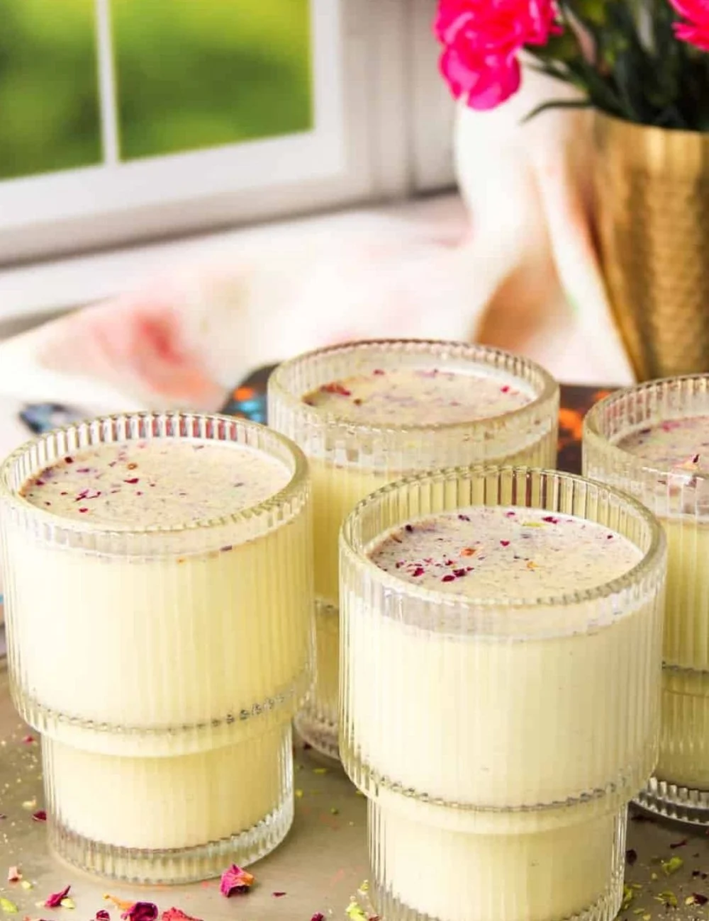 Chilled Thandai drink served with traditional Indian garnishes