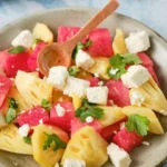 A vibrant Watermelon Feta Salad served in a bowl garnished with mint