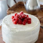 Whole Wheat Raspberry Honey Cake topped with fresh raspberries and honey glaze.