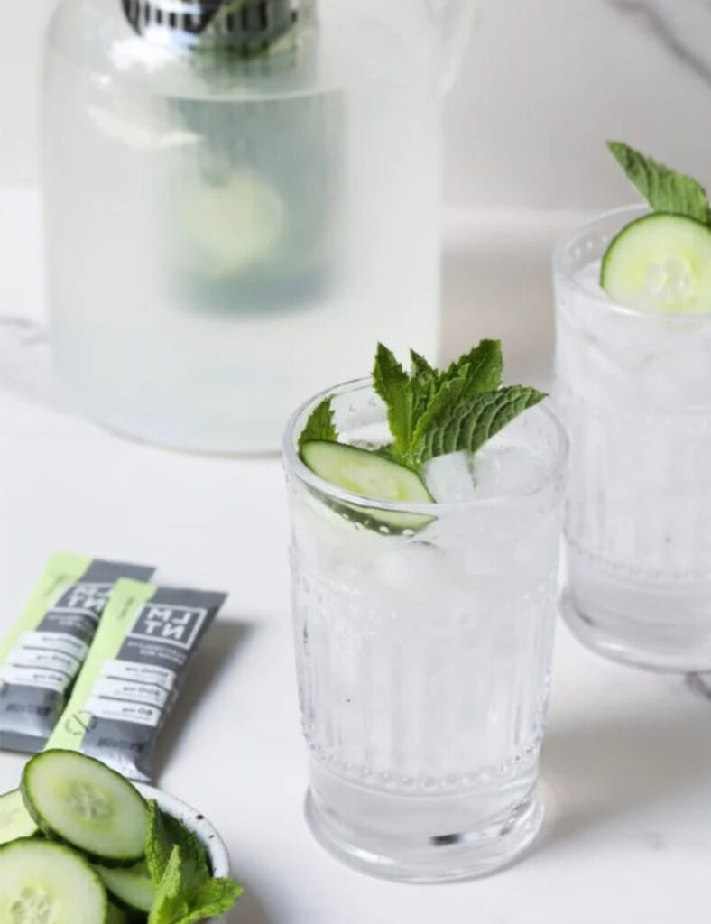 refreshing glass of cucumber water with slices of cucumber and mint leaves.