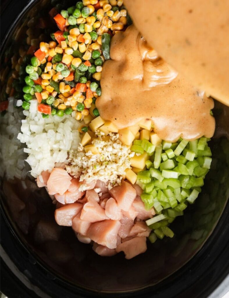 Once cooked, carefully shred the chicken directly in the slow cooker using two forks. The chicken should be tender and easy to pull apart.