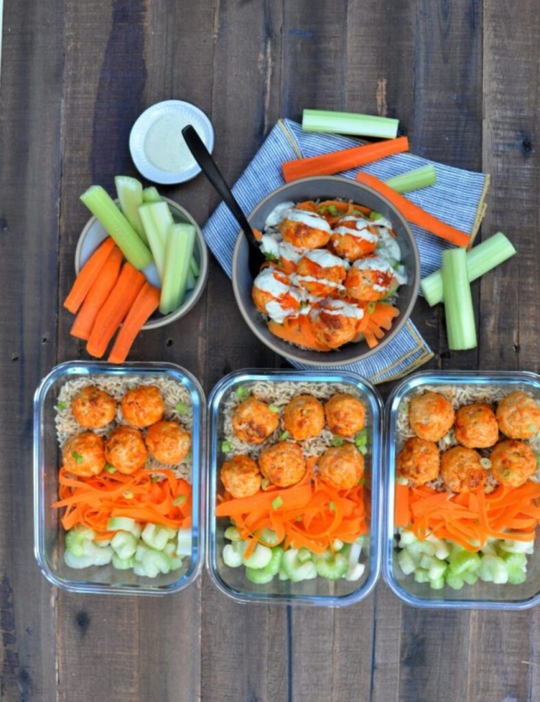 Buffalo Chicken Meatball Bowls with dipping sauce and fresh vegetables