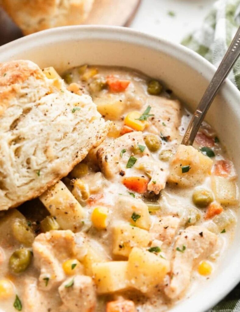 Bowl of slow cooker chicken pot pie soup with vegetables and chicken