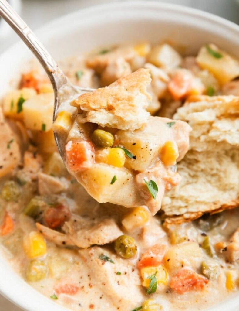 Bowl of slow cooker chicken pot pie soup with vegetables and chicken