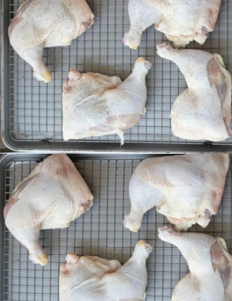  Six cooked chicken legs arranged neatly on a cooling rack, showcasing their golden-brown skin and crispy texture.