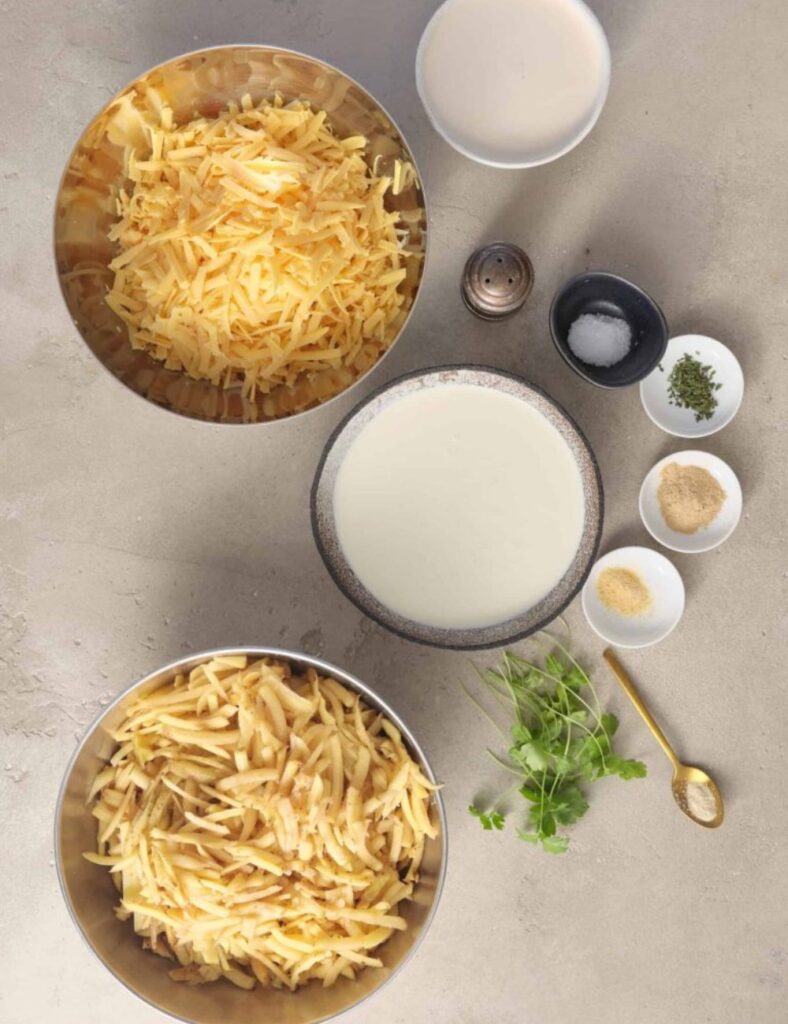 3 pounds of potatoes

1 cup of heavy cream

1 cup of grated cheddar cheese

1/2 cup of butter

1/2 cup of diced onions

Salt and pepper to taste