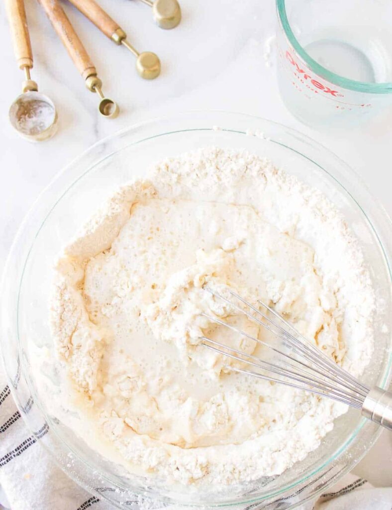 In a mixing bowl, combine the flour, baking powder, and salt. Stir well to ensure the baking powder is evenly distributed throughout the flour.