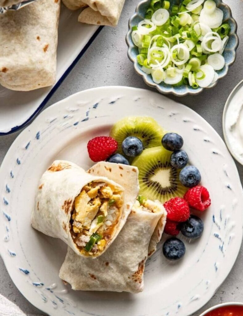 BURITOS AND FRUITS IN A PLATE