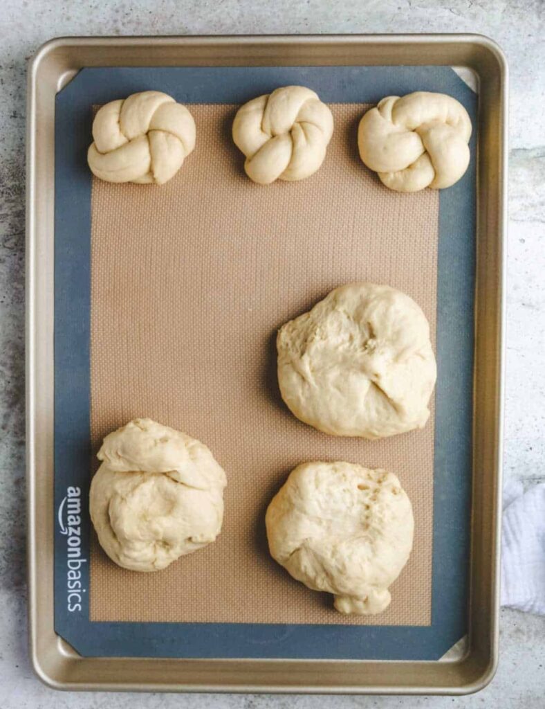 2. A baking sheet filled with round dough balls, prepared for the oven.

