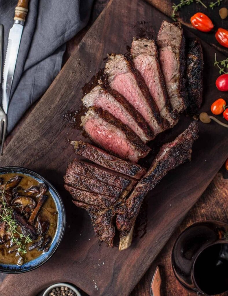 Juicy grilled Cowboy Ribeye Steak served on a plate