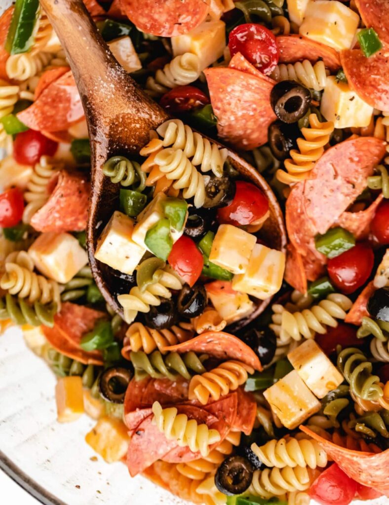 Italian pasta salad with fresh vegetables and dressing in a bowl
