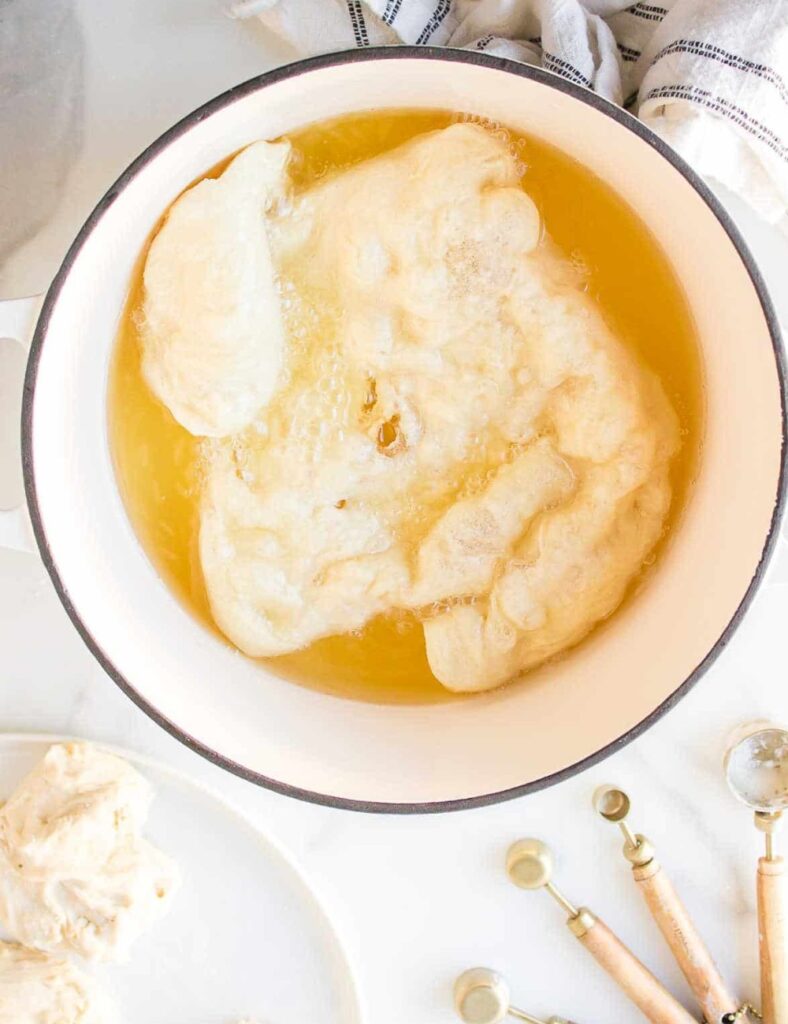 Carefully drop each piece into the hot oil, frying until golden brown on both sides, about 2-3 minutes per side.
