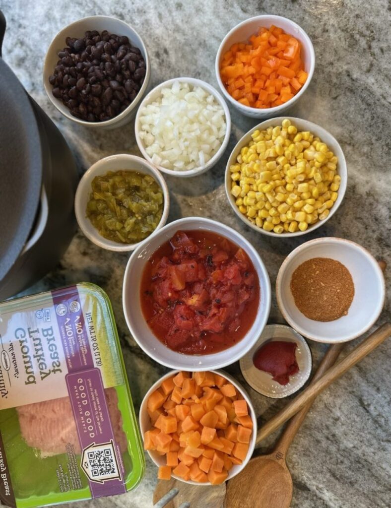 1 lb ground beef or turkey,
1 onion, chopped,
1 can (15 oz) black beans, drained and rinsed,
1 can (15 oz) kidney beans, drained and rinsed,
1 can (15 oz) corn, drained,
1 can (10 oz) diced tomatoes with green chilies,
1 packet taco seasoning,
4 cups beef broth or water,
Optional toppings: shredded cheese, sour cream, cilantro, avocado