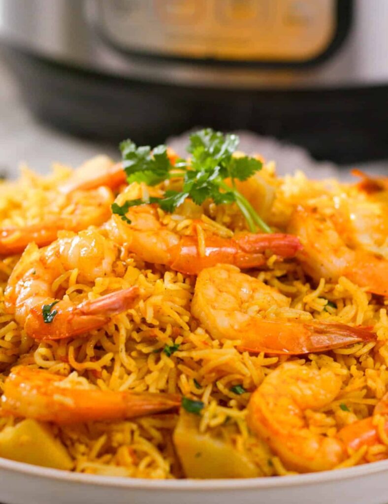 Delicious Instant Pot Shrimp Biryani served in a bowl, garnished with herbs.
