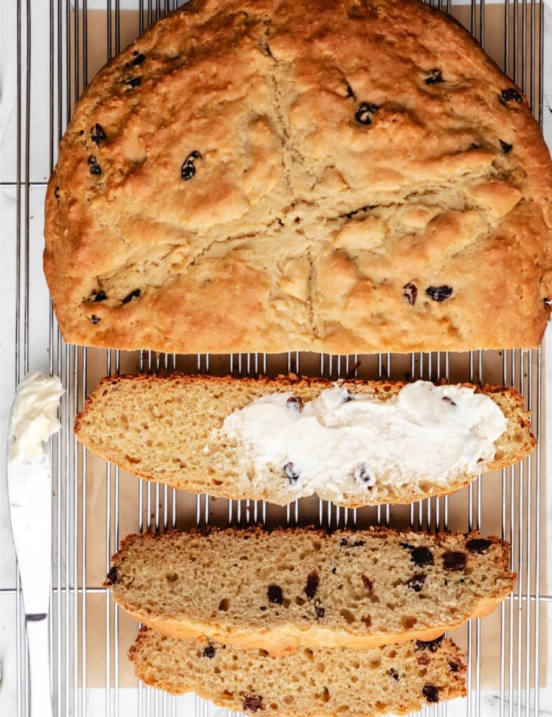 Freshly baked loaf of traditional Irish Soda Bread on a wooden table