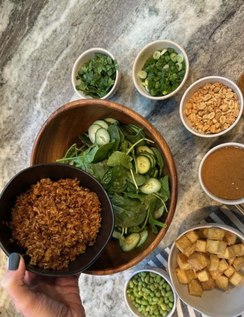 A trendy green salad with fresh vegetables and colorful toppings served in a bowl.