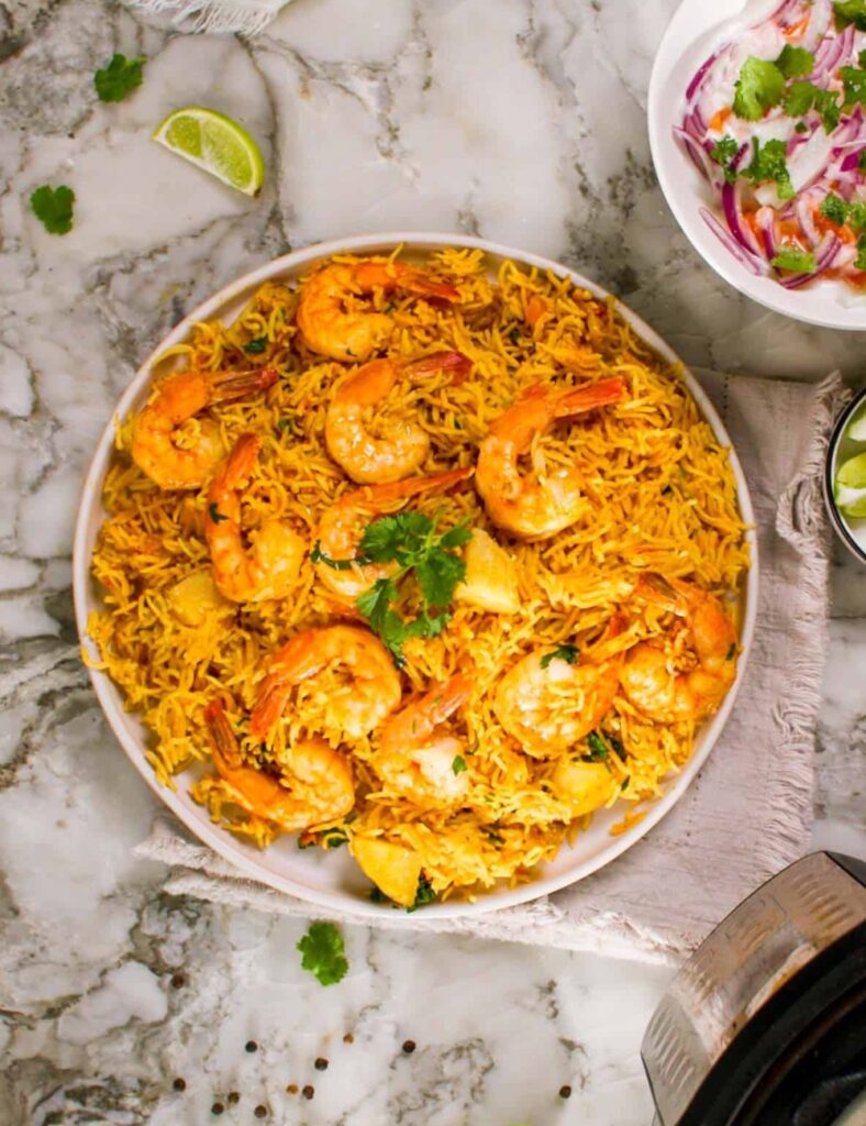 Delicious Instant Pot Shrimp Biryani served in a bowl, garnished with herbs.