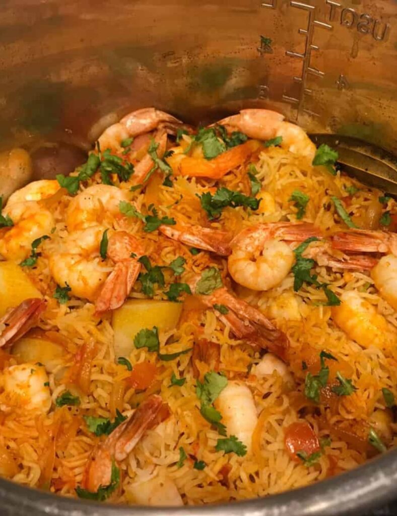 Delicious Instant Pot Shrimp Biryani served in a bowl, garnished with herbs.