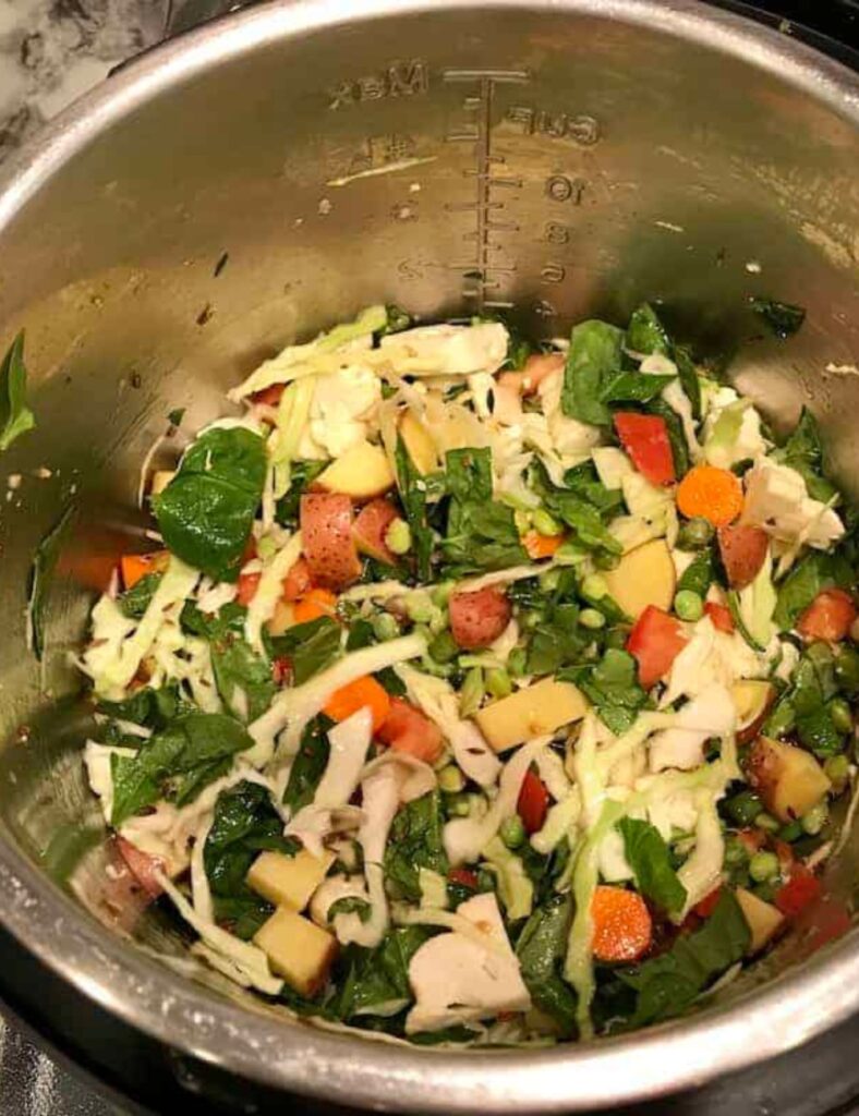 A vibrant bowl brimming with assorted vegetables and other ingredients, showcasing a healthy culinary preparation.