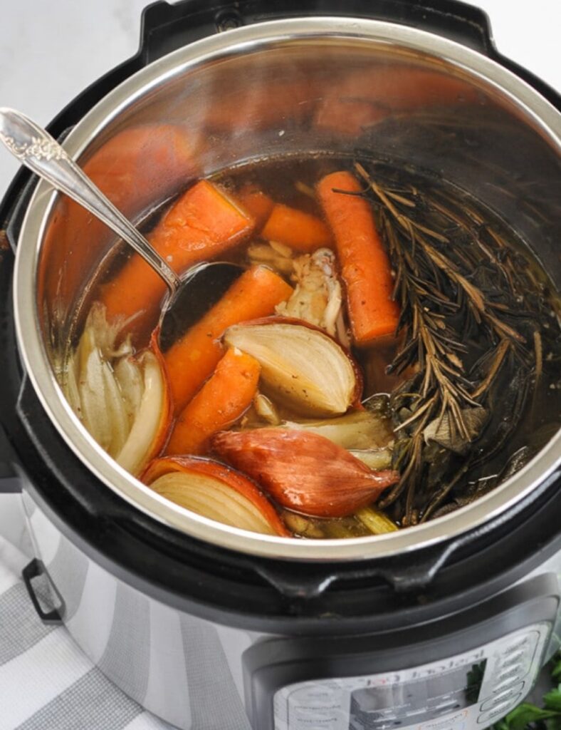 Add the quartered onion, chopped carrots, chopped celery, and smashed garlic to the pot. These vegetables will enhance the flavor of your broth.
